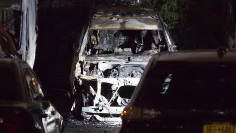 shell of a burnt out NYPD car