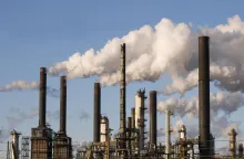 May the Antagonism Generalize A photo of smoke billowing from factory chimneys with a clear sky in the background