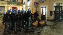 roma cops cowering behind debris likely thrown at them