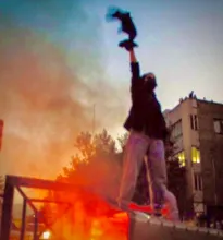 Picture: Woman standing on a burning rubbish bin, waving her veil. Tehran, 1 October 2022, https://freethinker.co.uk Picture: Woman standing on a burning rubbish bin, waving her veil. Tehran, 1 October 2022, https://freethinker.co.uk