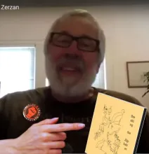 R.A.t.M. fan holds a copy of "Breaking the Alphabet" by Sascha Engel. (c. 2022, colorized) R.A.t.M. fan holds a copy of "Breaking the Alphabet" by Sascha Engel. (c. 2022, colorized)