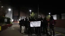 anarchists with a banner that says "Solidarity with Toby Shone"
