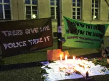 two banners from berlin's vigil for comrade tort, reading "trees saves life, police take it" and "mourn the dead, fight fo the living"